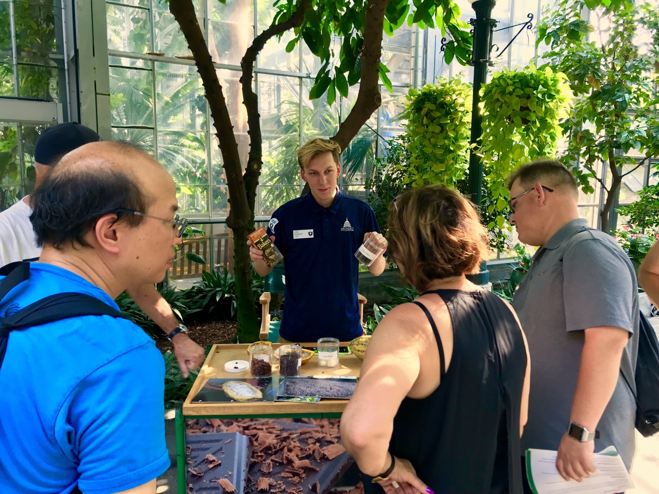 Intern Asa talks about Theobroma cacao (chocolate) with visitors