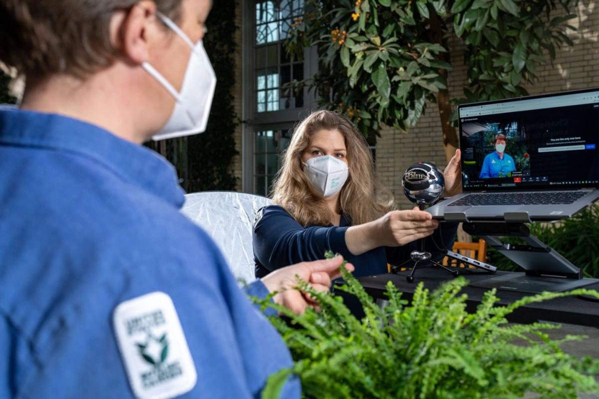 Grace Anderson adjusts the camera and laptop for an online horticultural education program.